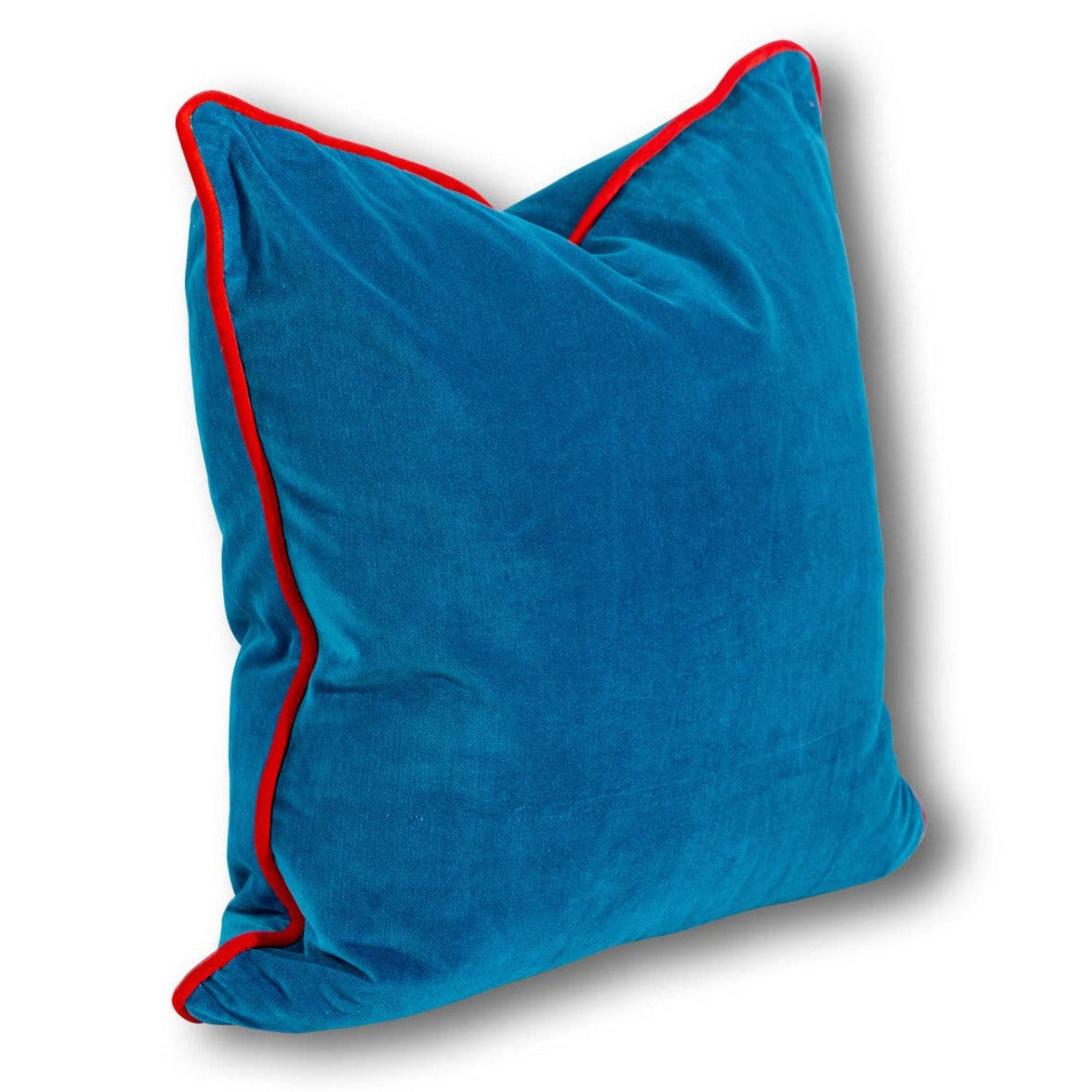 A Peacock blue velvet square pillow with bright red trim.